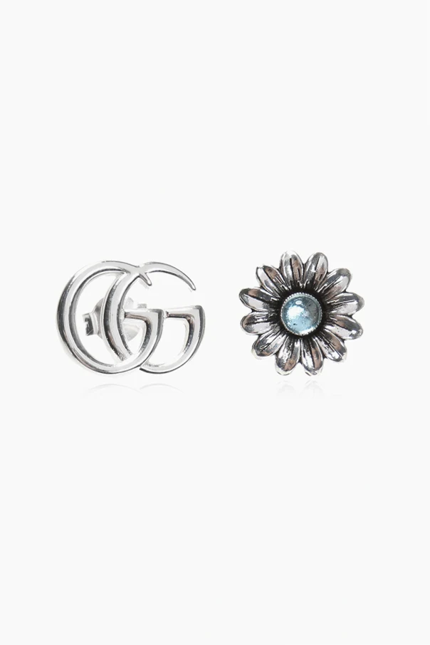 SILBER Silver earrings in the shape of a logo and a flower.