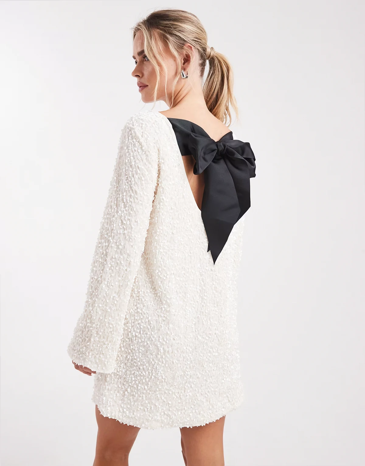 – Biała cekinowa sukienka mini z kokardką z tyłu