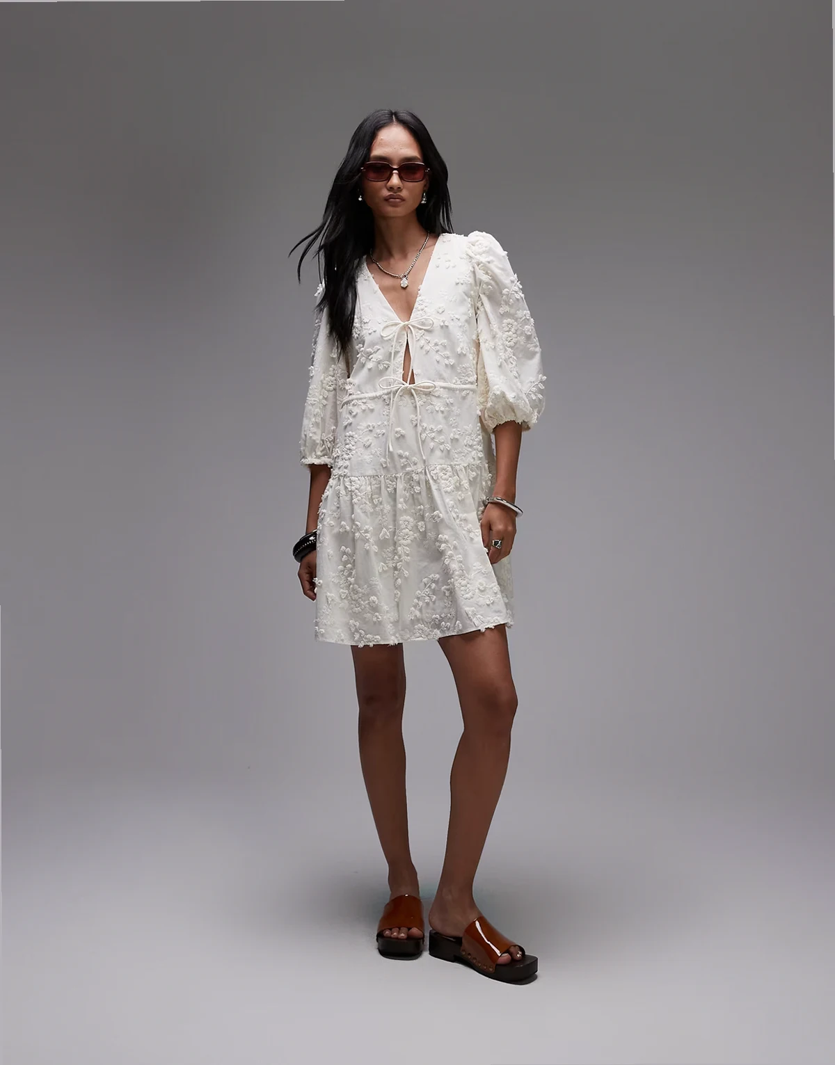 embroidered mini dress with front tie detail and tiered hem in white