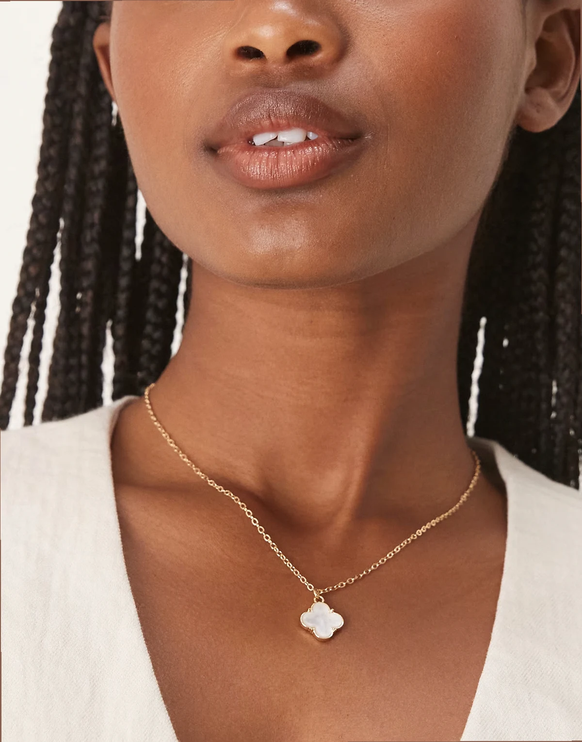 white stone clover pendant necklace in gold tone