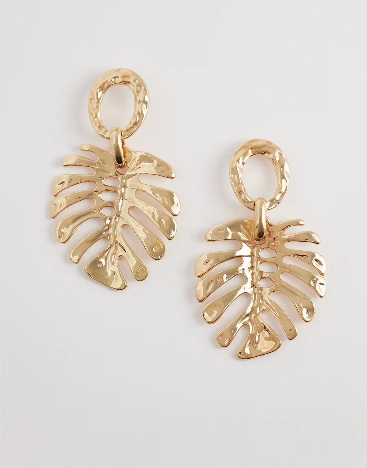 statement palm leaf earrings in gold