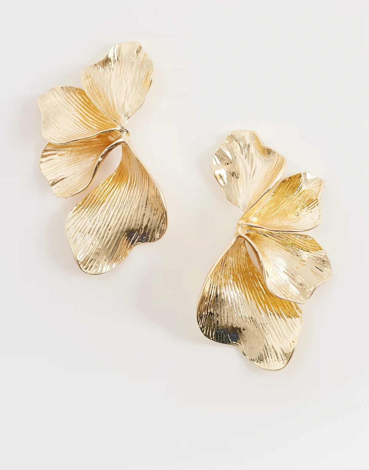 statement flower earrings in gold