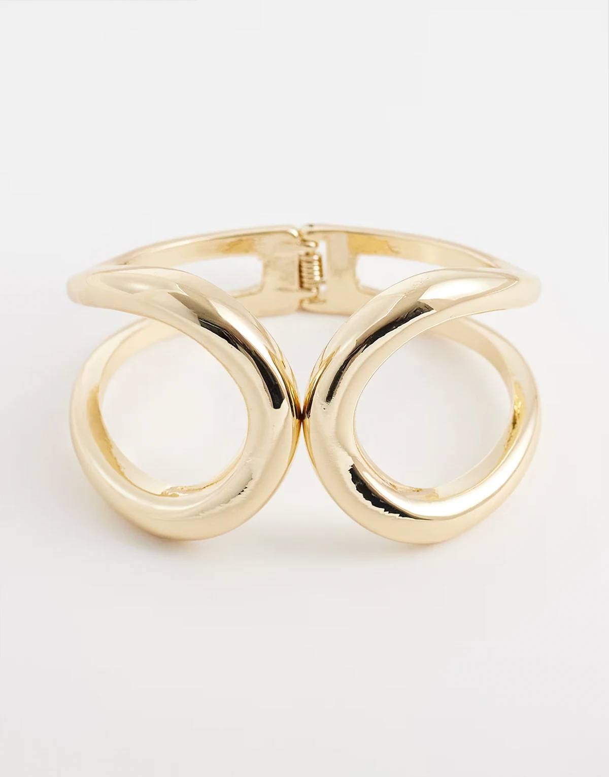 – Bransoleta mankiet w odcieniu złota z abstrakcyjnym kształtem