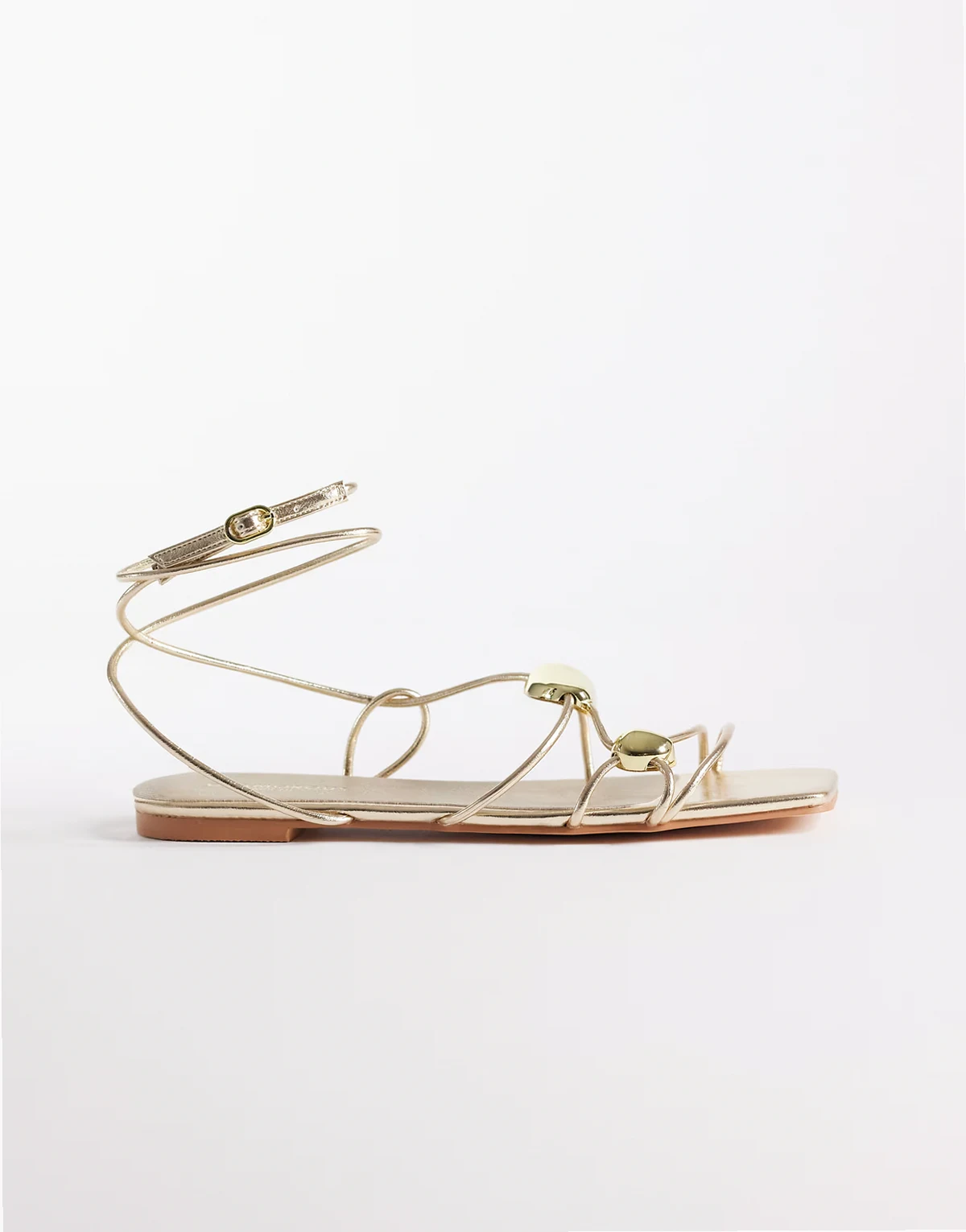 flat sandals with gold detailing in gold