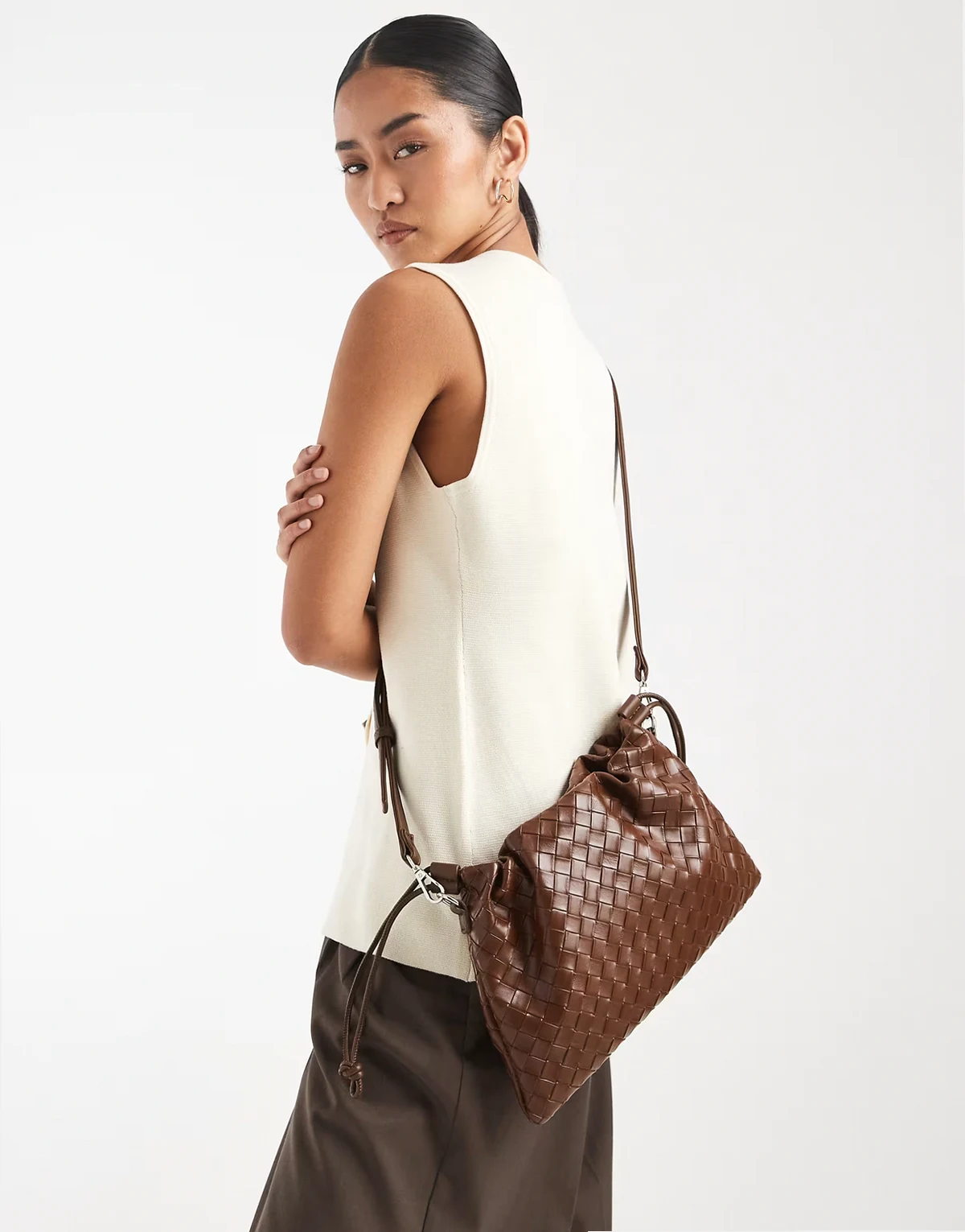 woven drawstring crossbody bag in dark brown