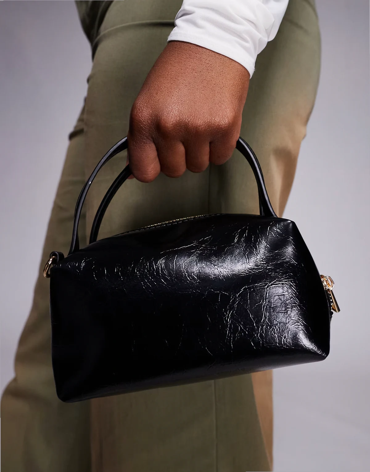 textured mini grab clutch with cross body strap in black