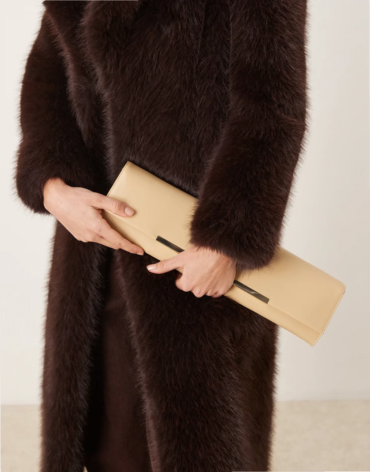 slim elongated clutch purse with bar detail in buttermilk