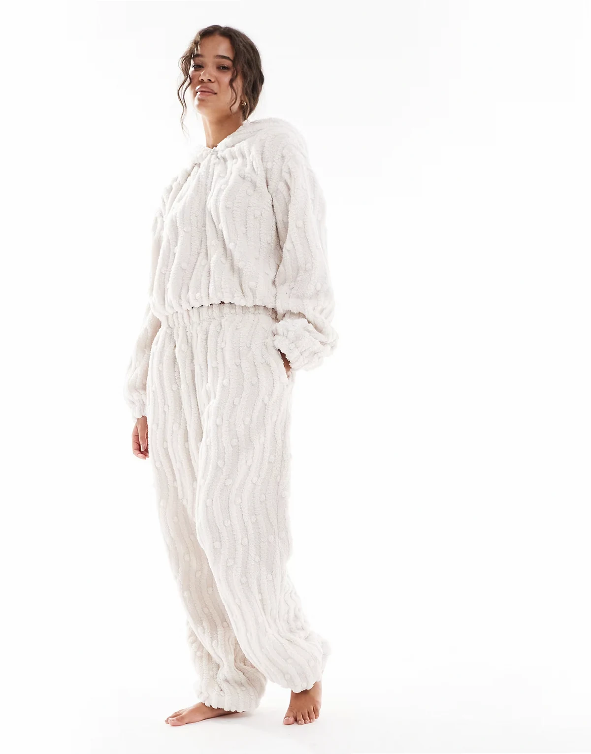 – Kremowe polarowe spodnie z szerokimi nogawkami i falistym wzorem z kulkami, część zestawu