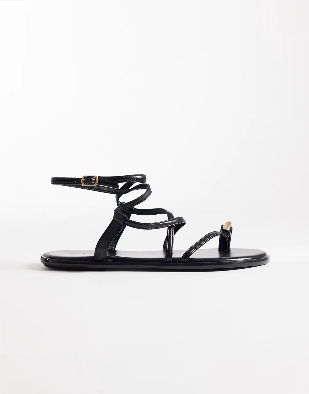 strappy flat sandals with gold-tone embellishment in black