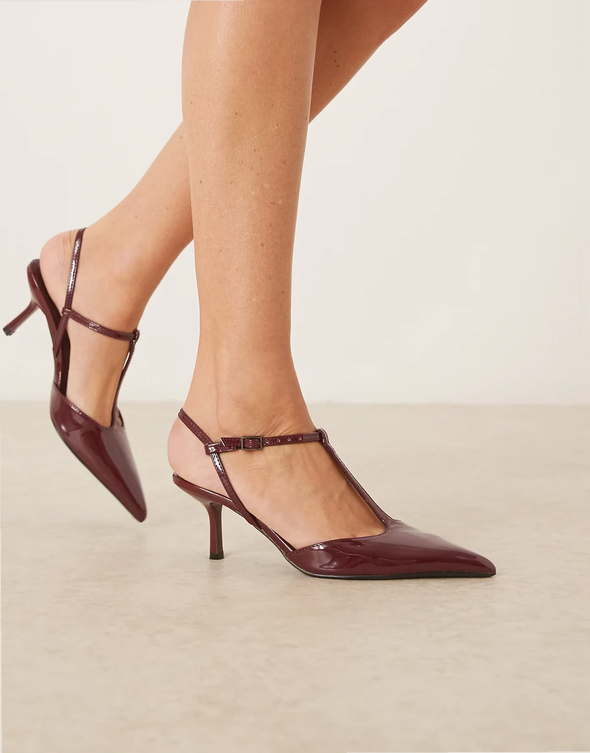 – Lakierowane bordowe buty na obcasie z noskami w szpic i paskiem za piętą