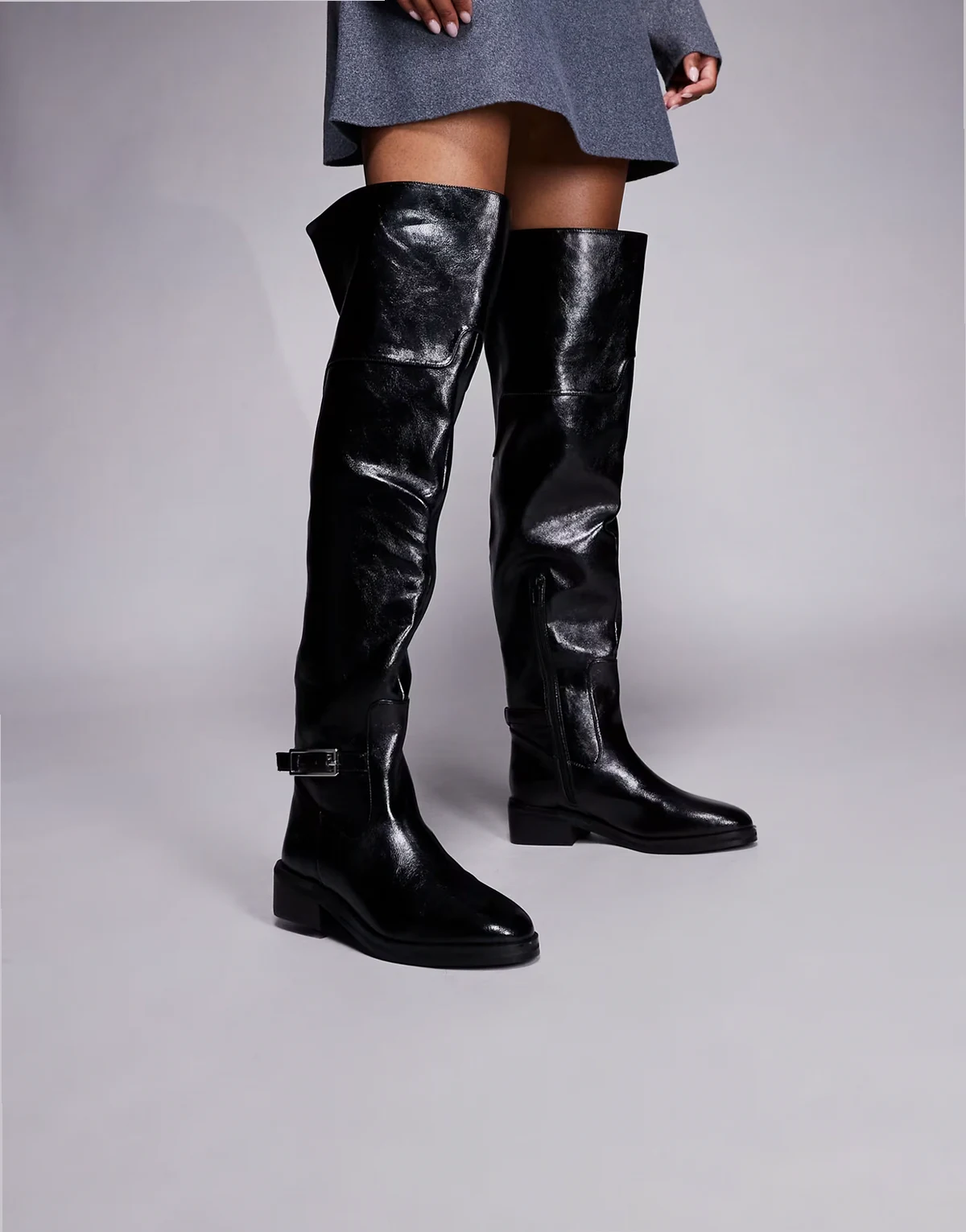 buckle over the knee boots in black