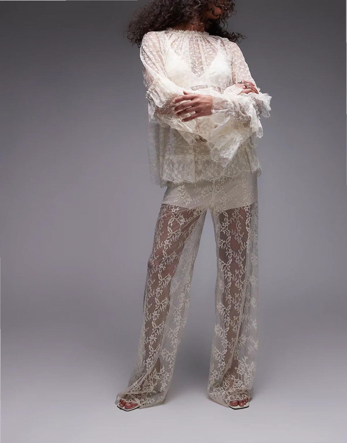 sheer lace pants with scalloped hem and fitted micro shorts in off white