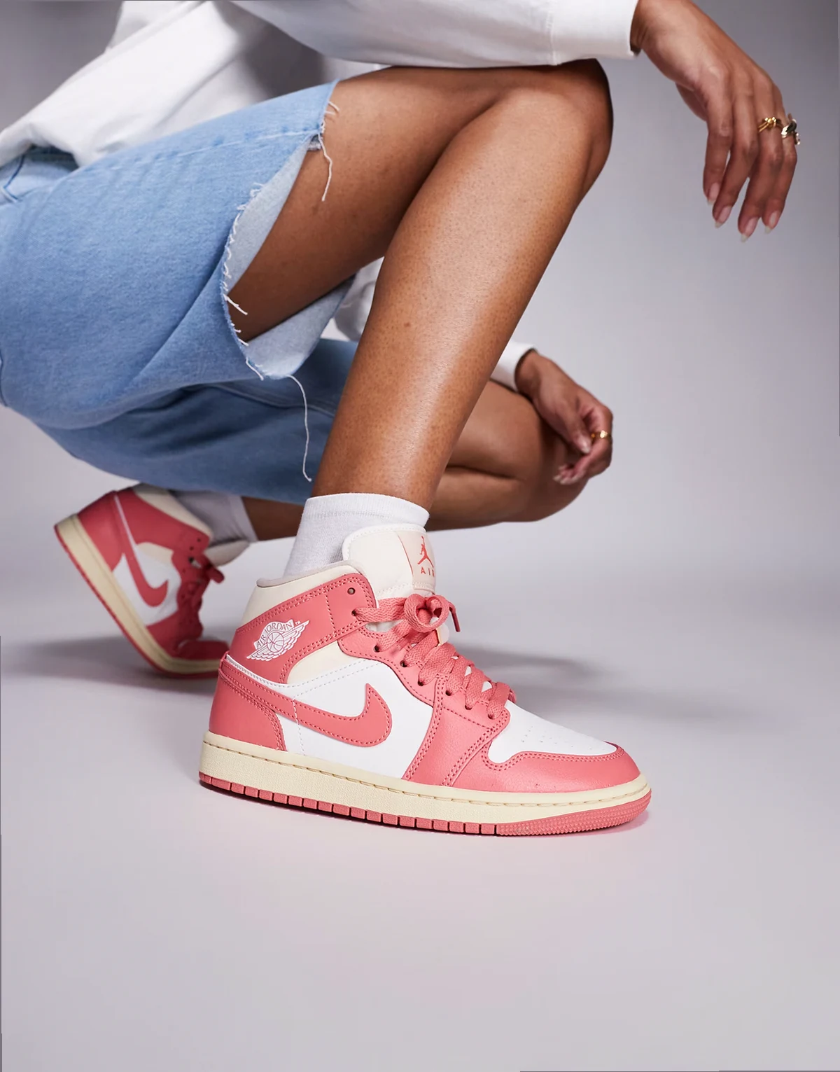 Nike Air Jordan 1 Mid sneakers in pink and white