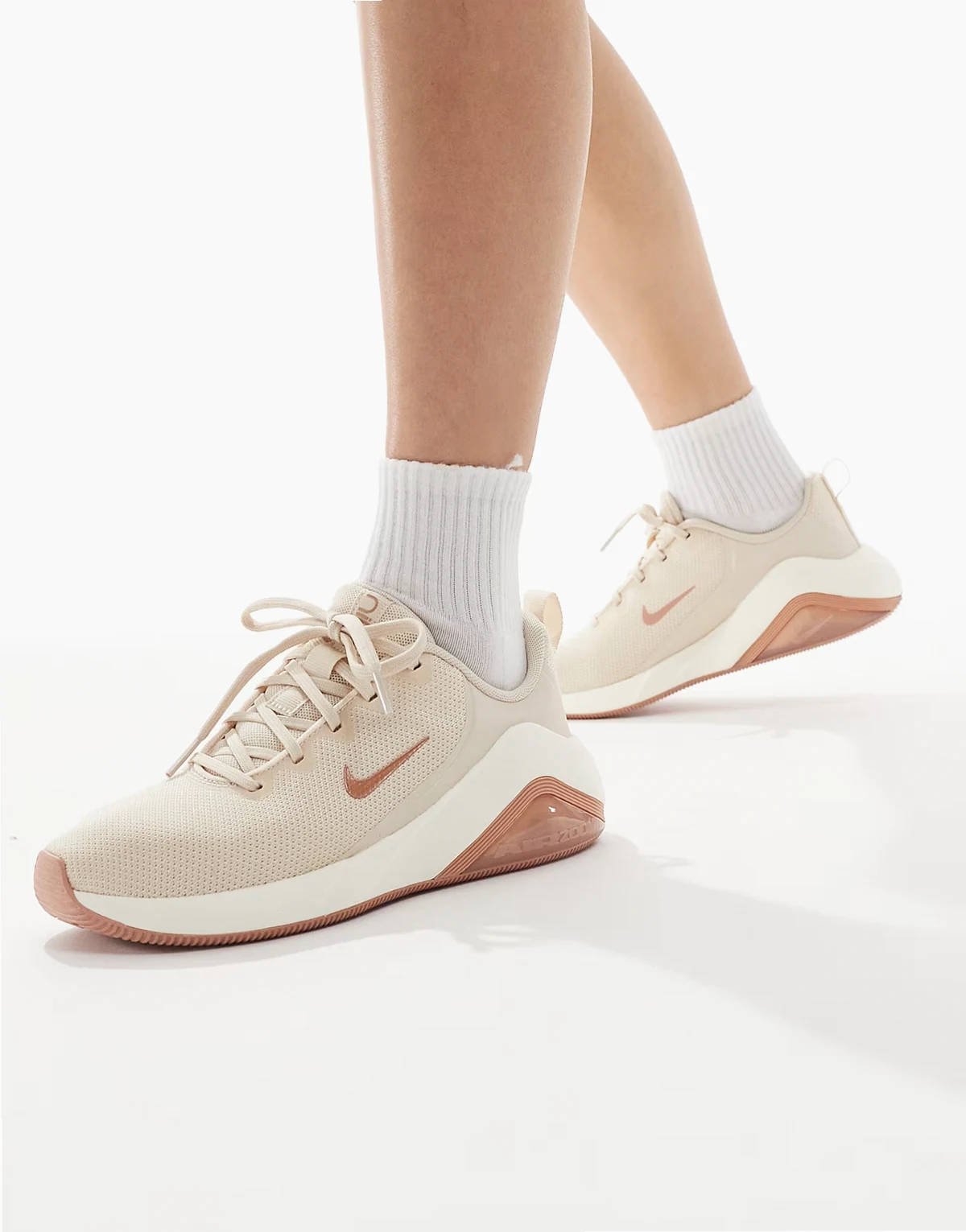 Nike Bella 7 sneakers in rose gold