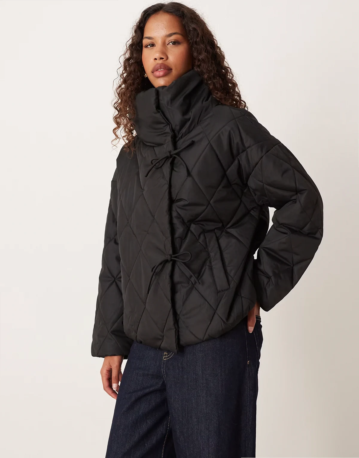 high neck quilted jacket with tie details in black