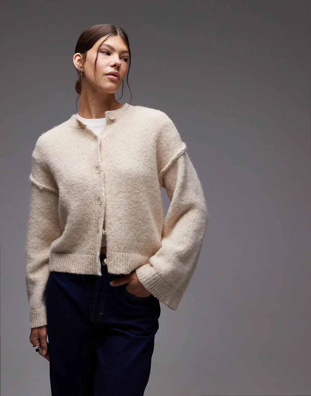 knit cardigan with exposed seams with wool in cream