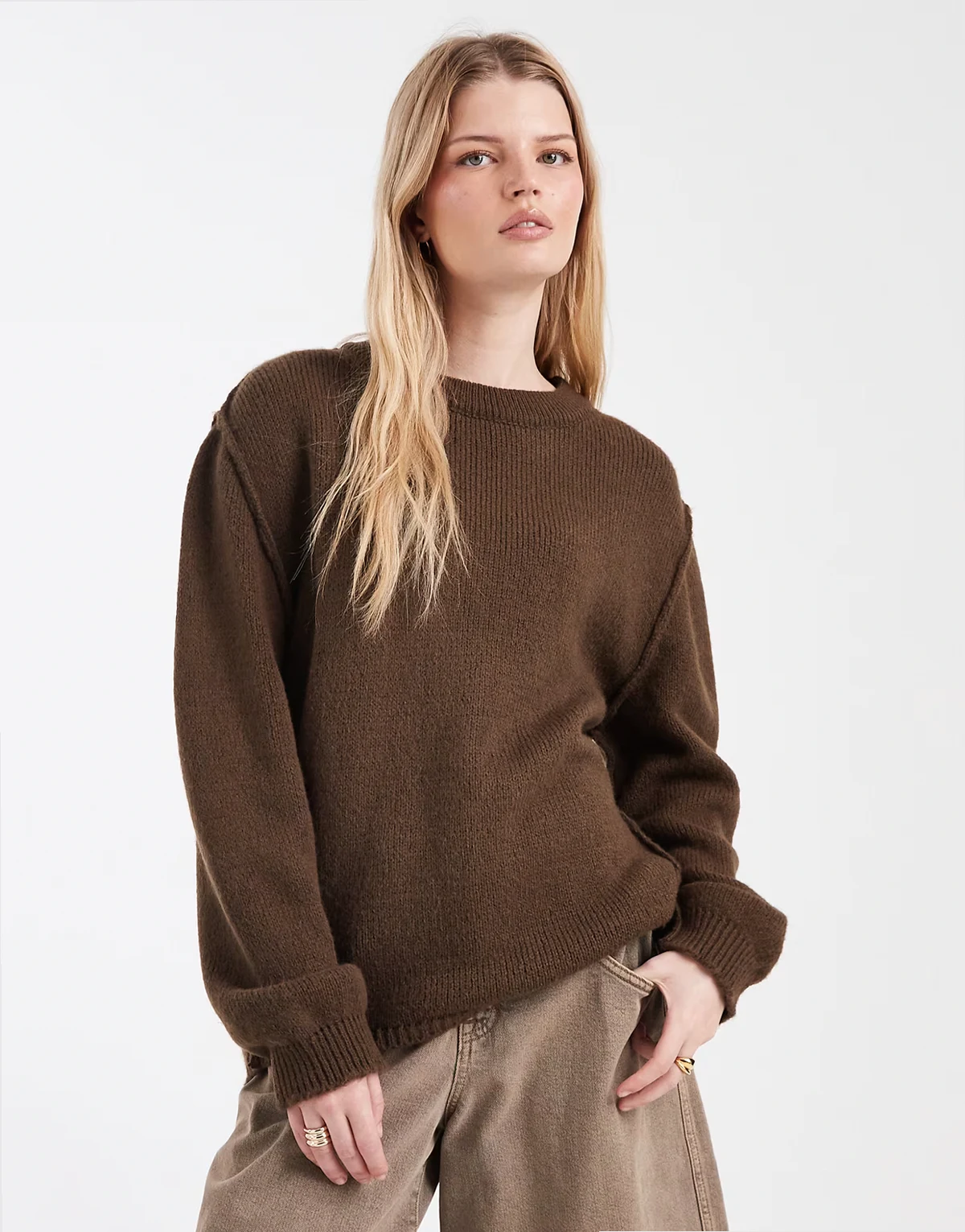 oversized knit sweater with exposed seams in brown