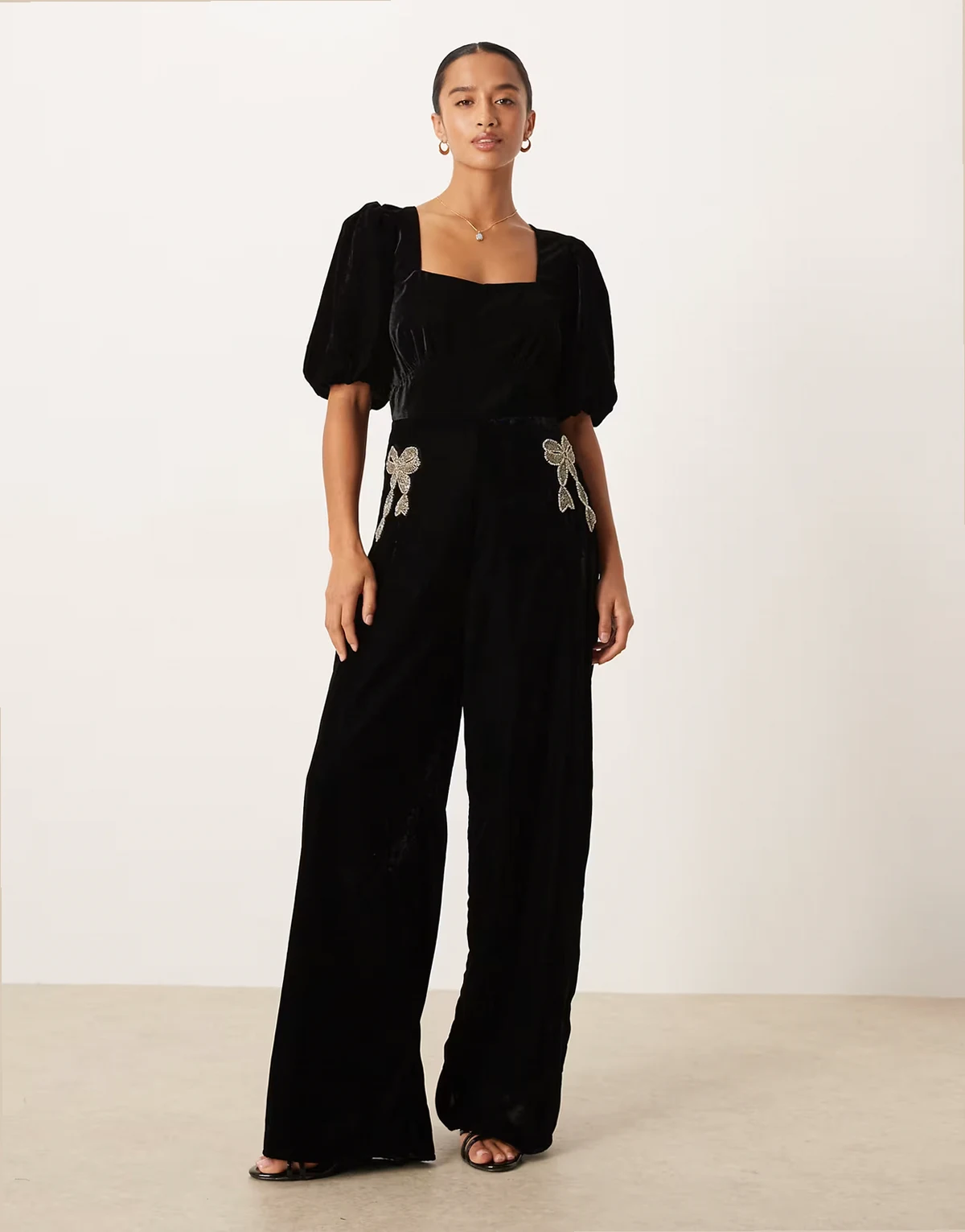 square neck velvet jumpsuit with embellished bows in black