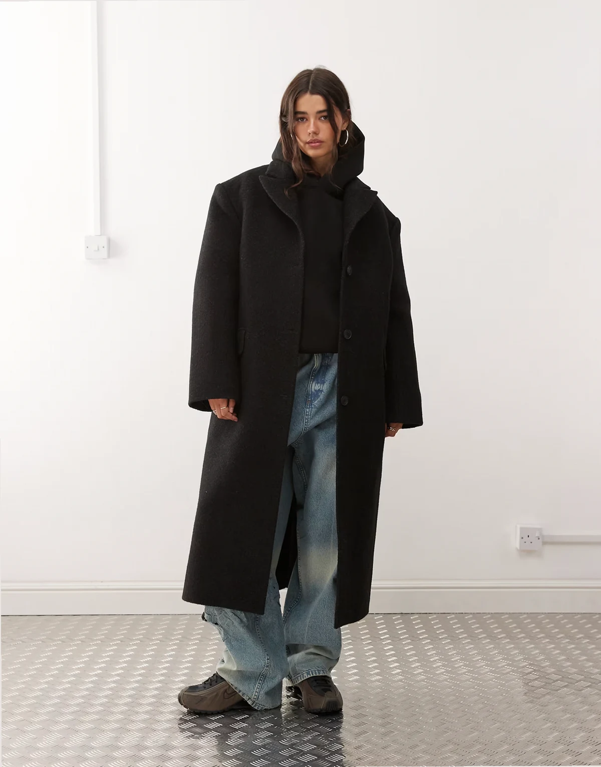 wool blend oversized coat with exaggerated shoulders in black herringbone
