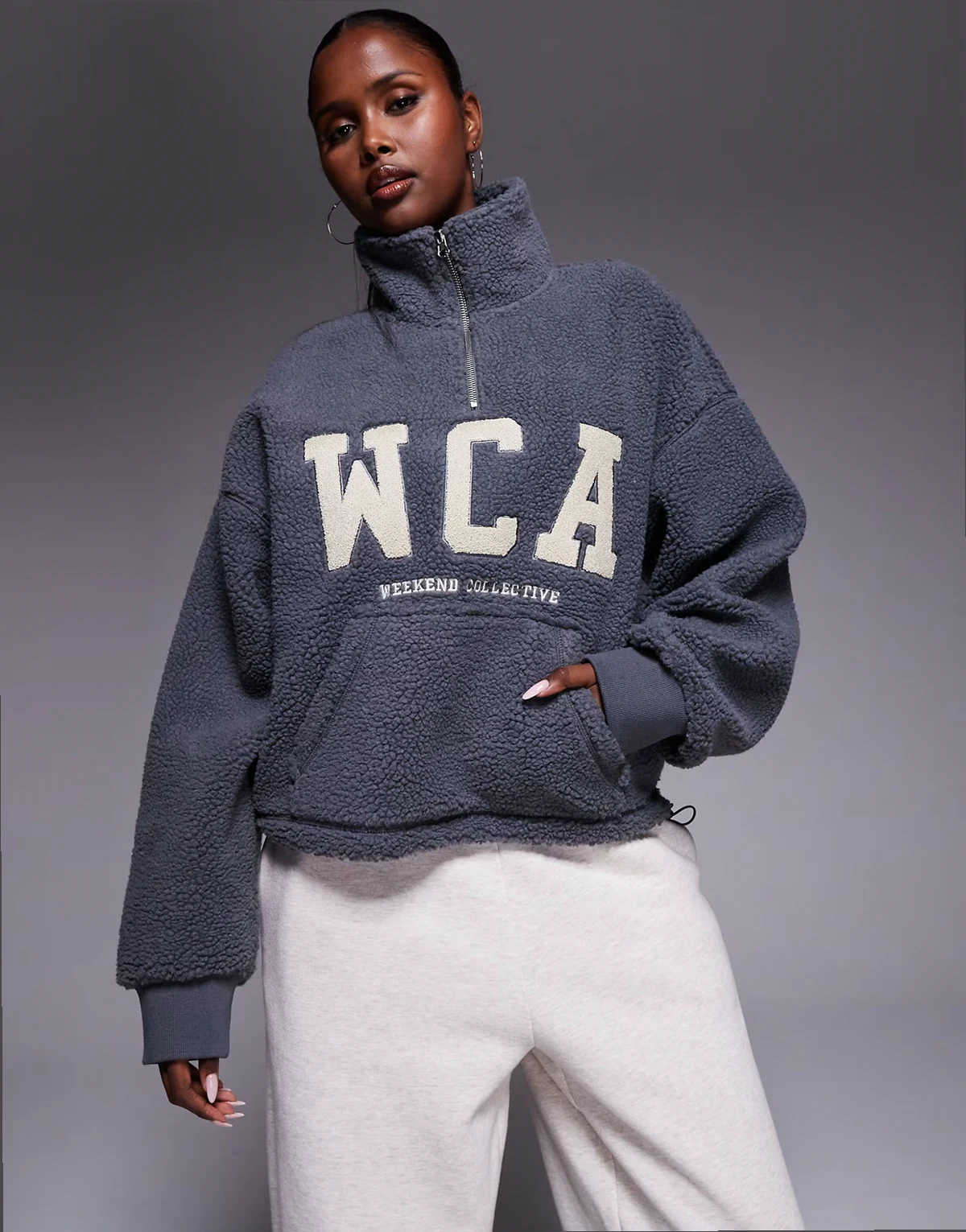 Weekend Collective half zip cropped fleece in gray with varsity graphic detail