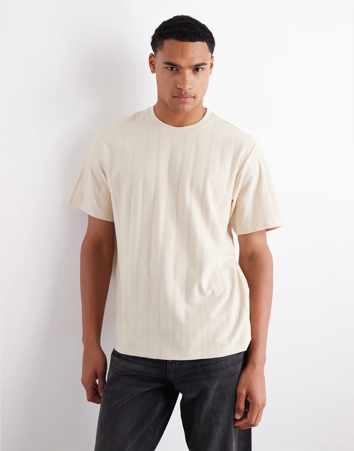 – Kremowy fakturowany T-shirt oversize w paski