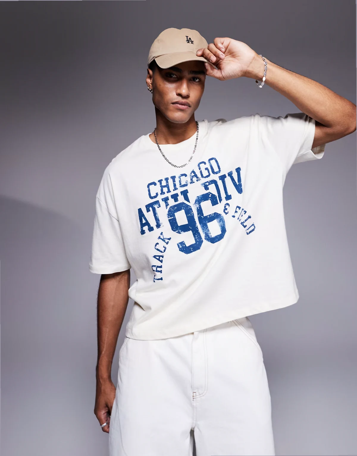 – Kremowy T-shirt oversize o pudełkowym kroju ze sportową grafiką