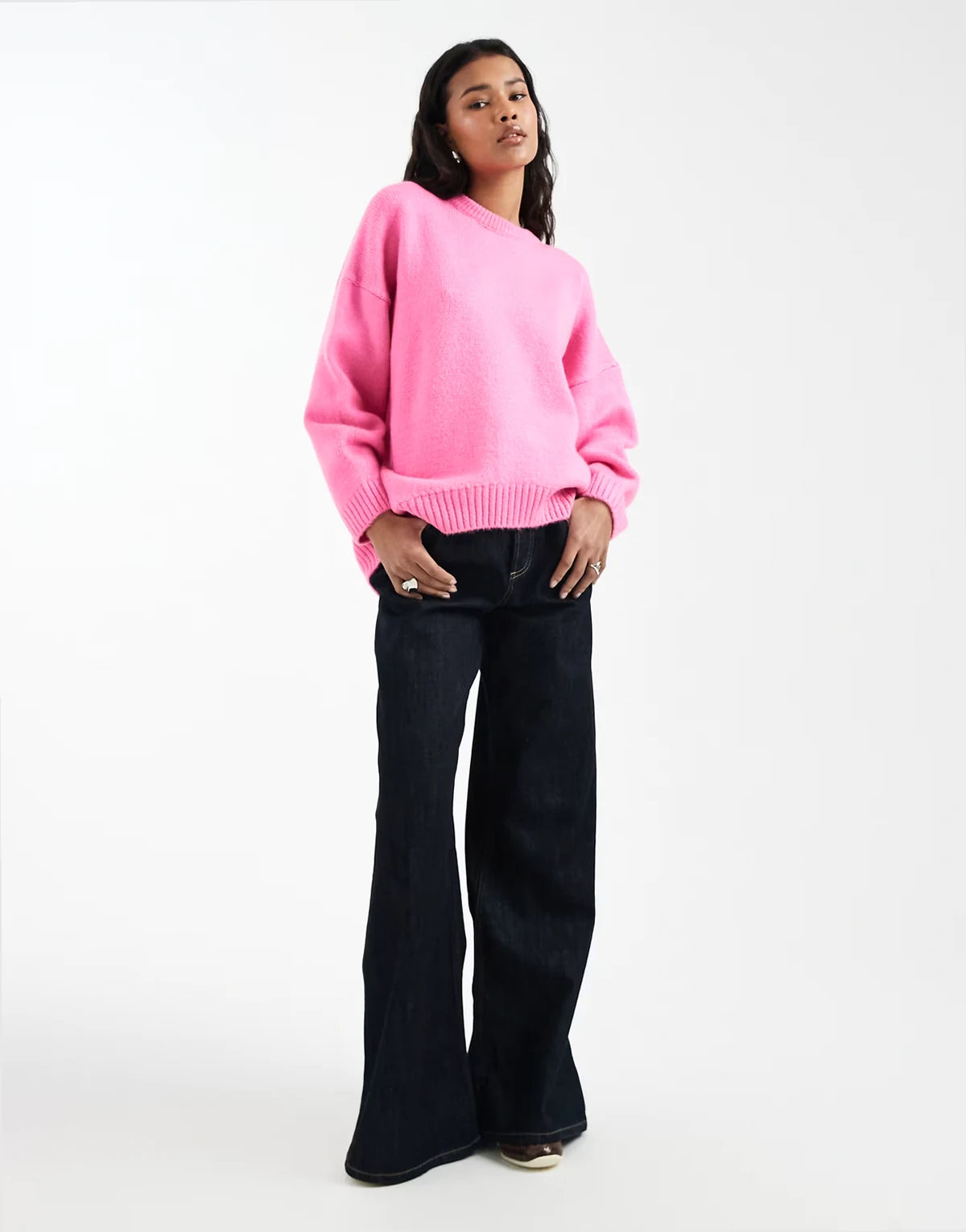 oversized crew neck sweater with curved hem in bright pink