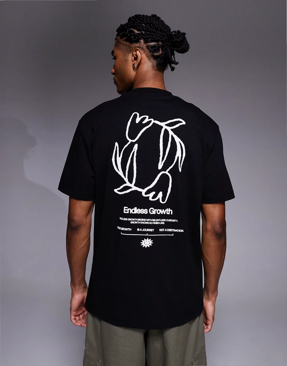 – Czarny T-shirt o luźnym kroju z kwiatową grafiką i napisem