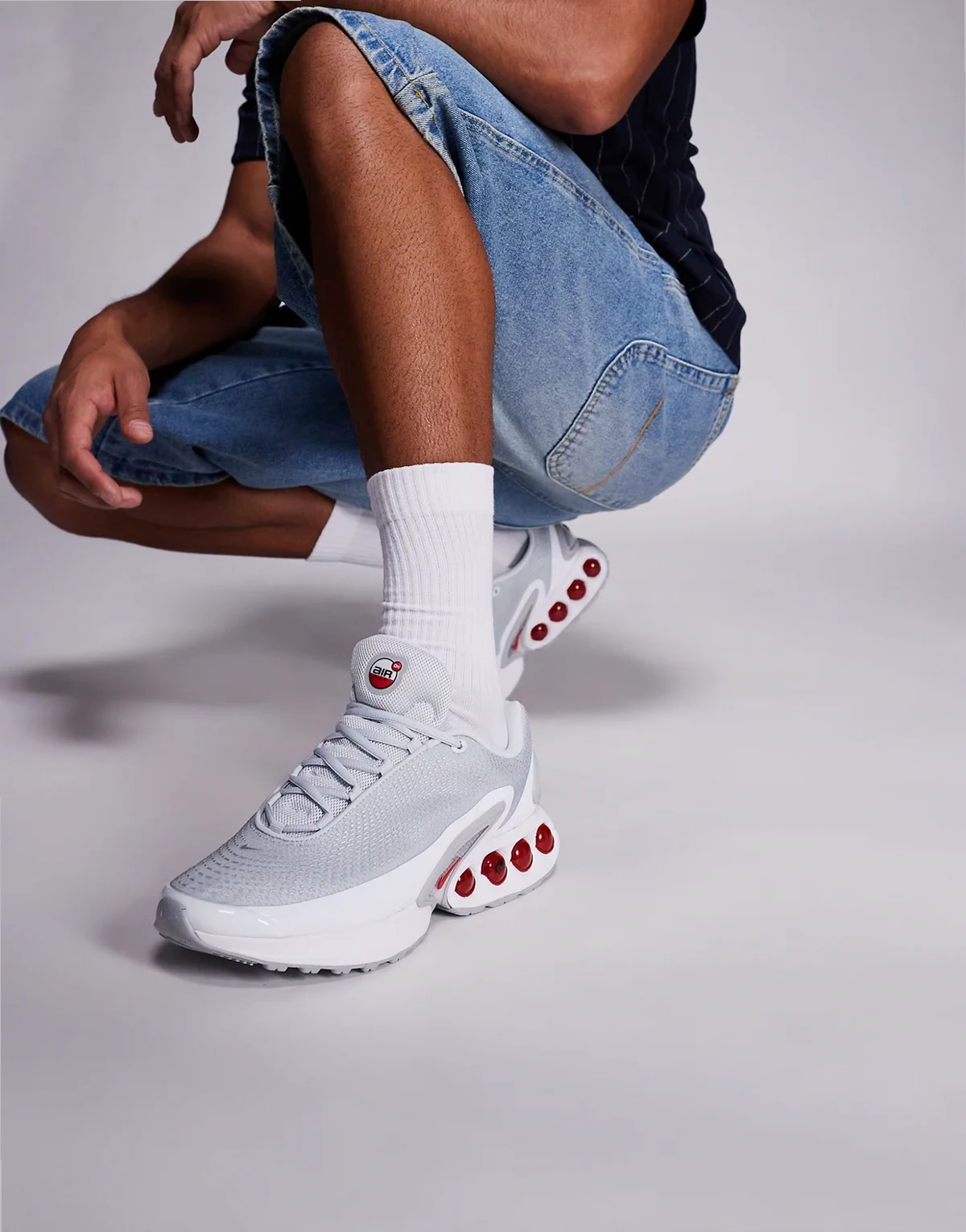Air Max DN sneakers in light gray and red