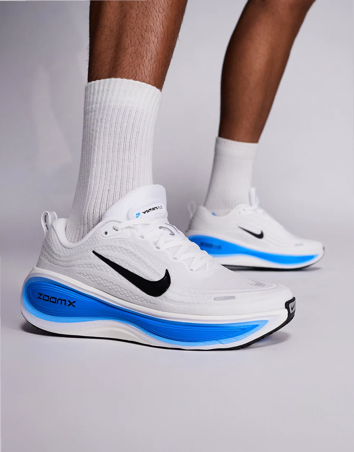 Nike Running Vomero Plus sneakers in white and blue