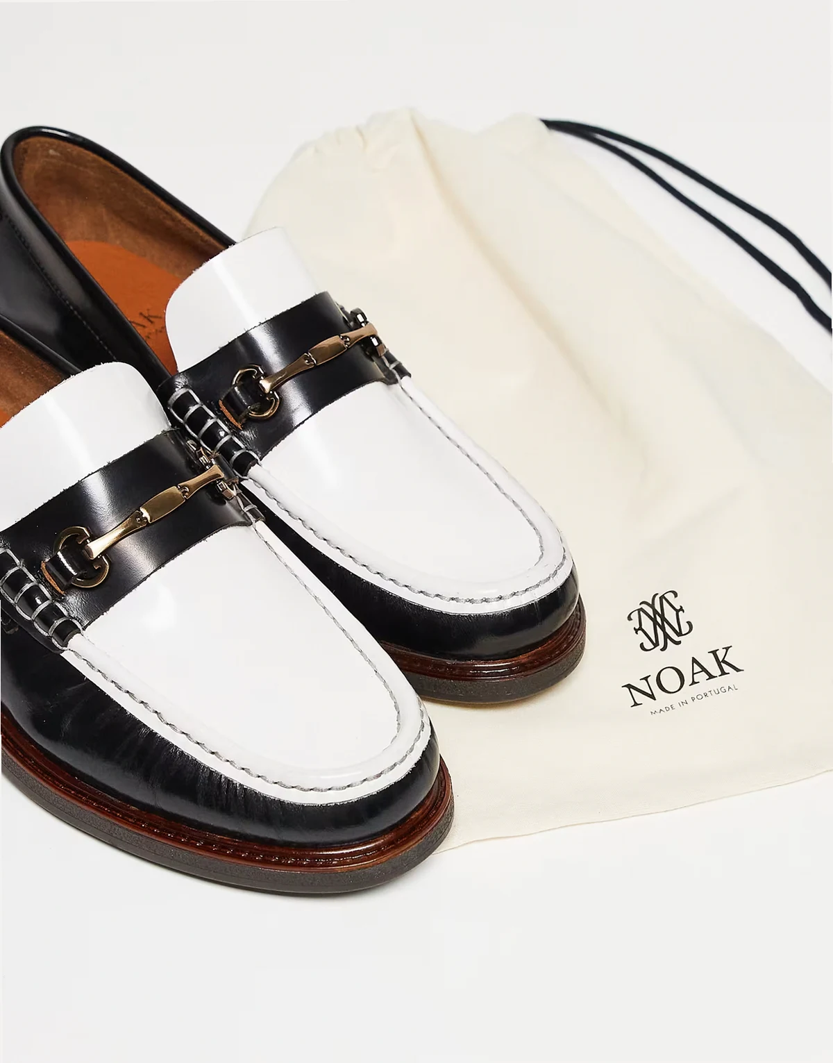 made in Portugal penny loafers in black and white leather with gold snaffle