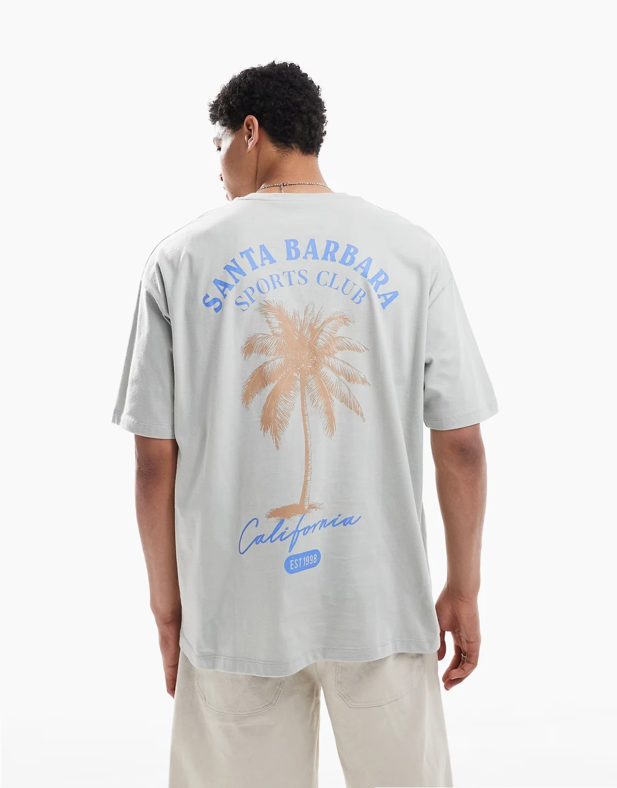 – Jasnoszary T-shirt oversize z grafiką z palmą