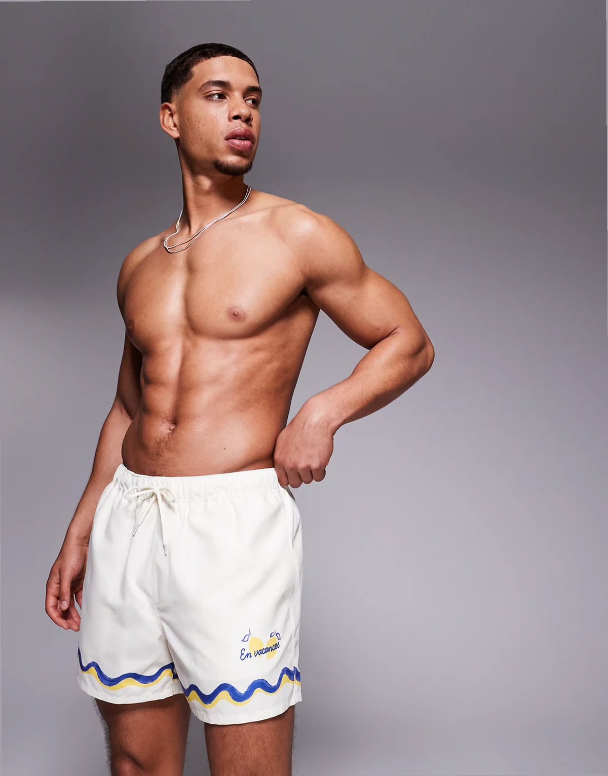 swim shorts in short length with border print in stone