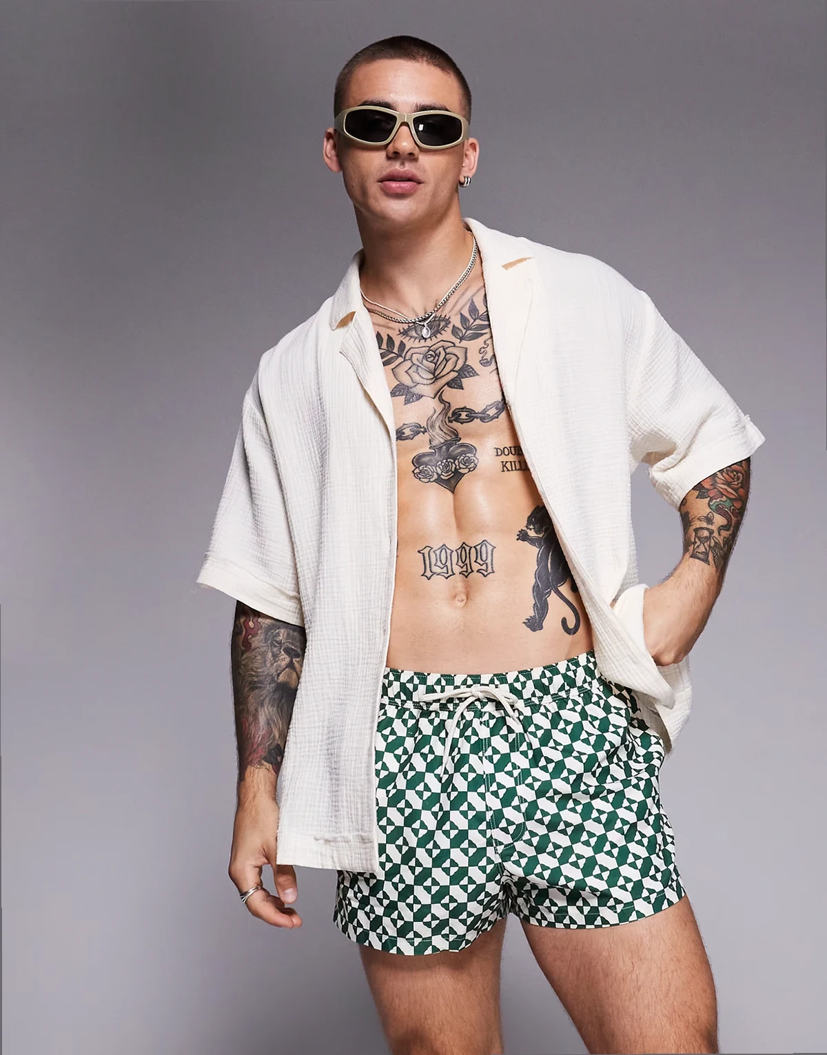 super short length swim shorts in green geo print