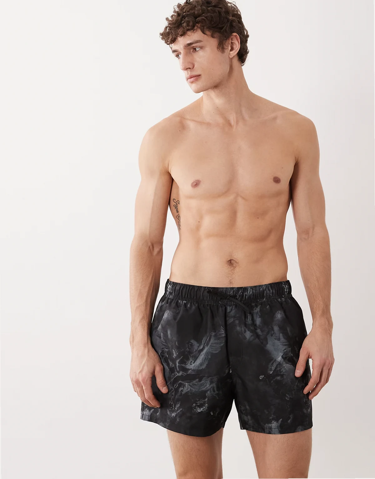 swim shorts in short length with cherub print in black