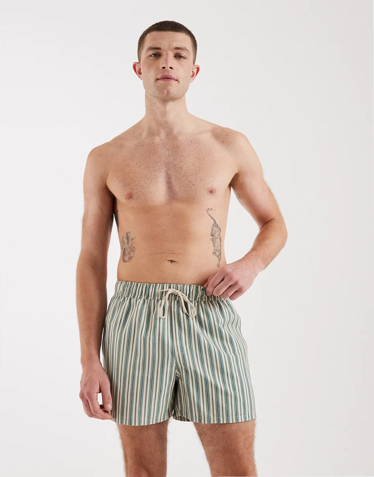 swim shorts in short length in beige with green pattern stripe