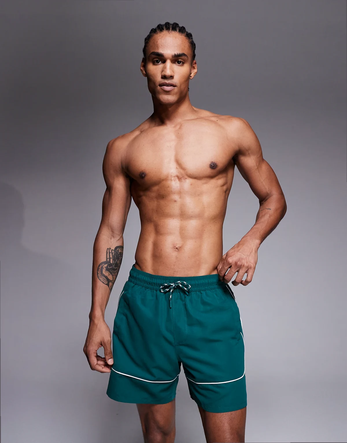 mid length swim shorts in dark green with contrast white binding