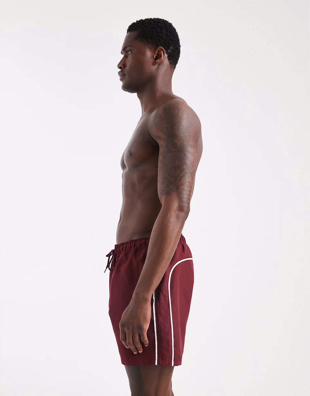 swim shorts in mid length in burgundy with contrast white binding