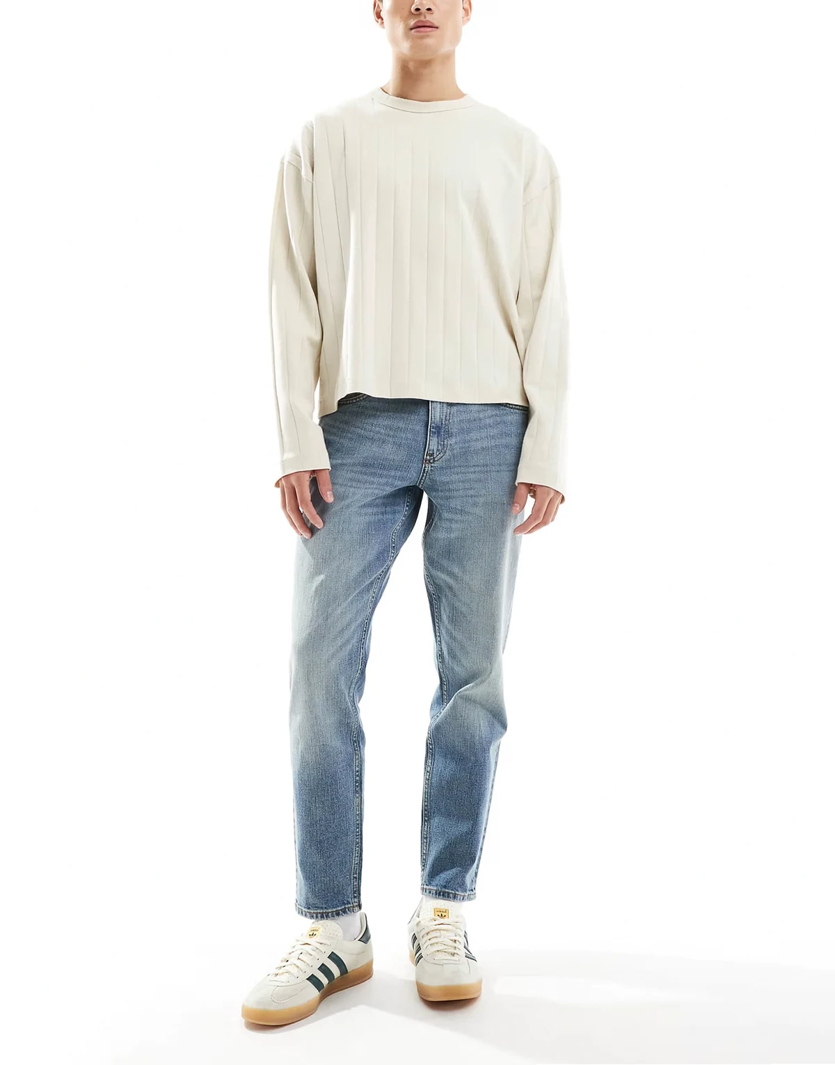stretch tapered jeans in mid wash blue