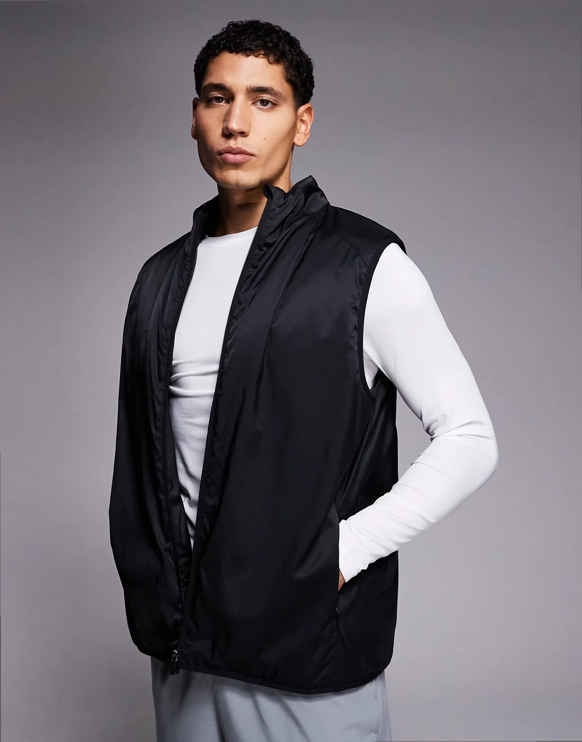 insulated thermal running vest with zip pockets and reflective detail in black