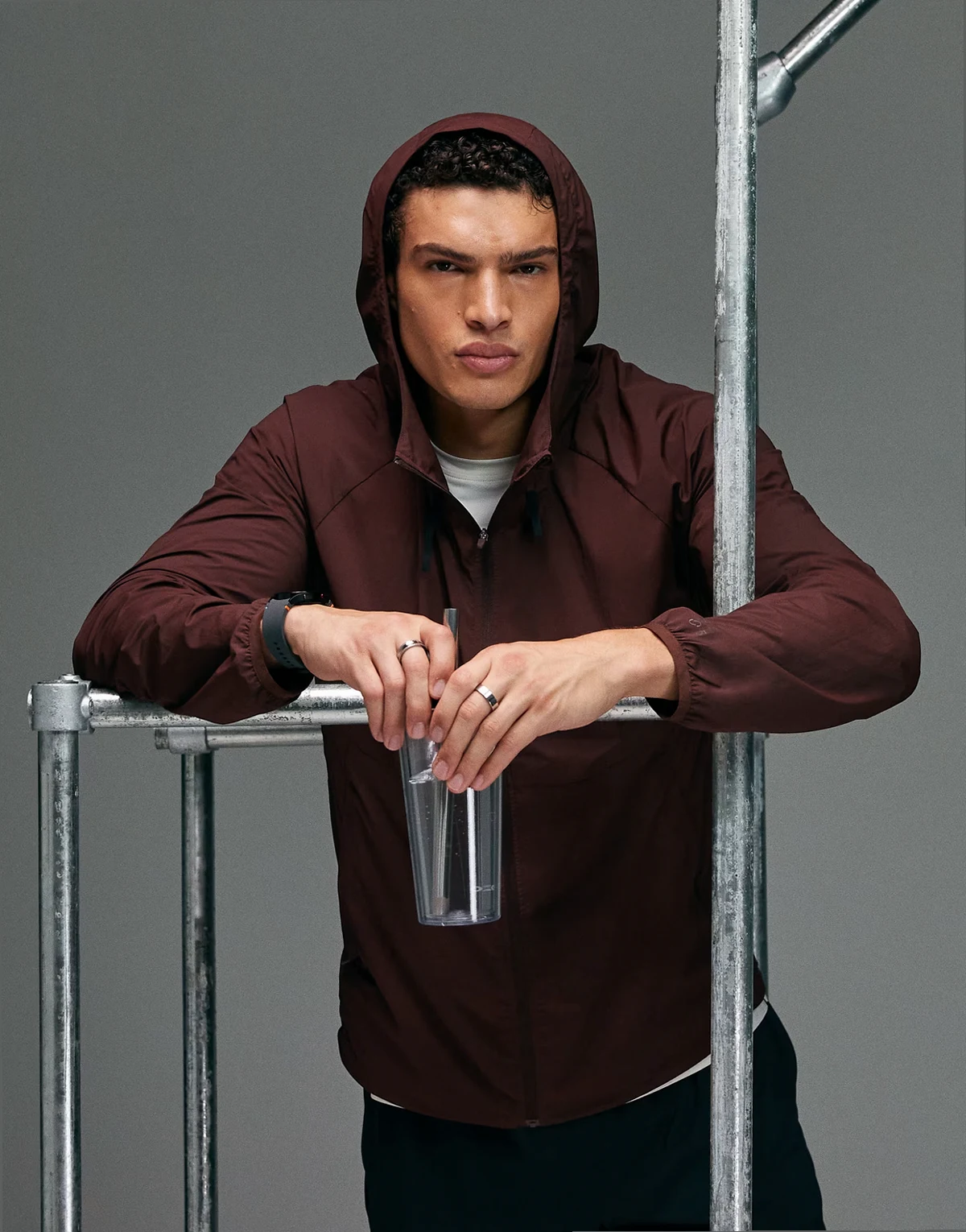 Premium zip up hooded water repellent running jacket with zip pockets in deep mahogany