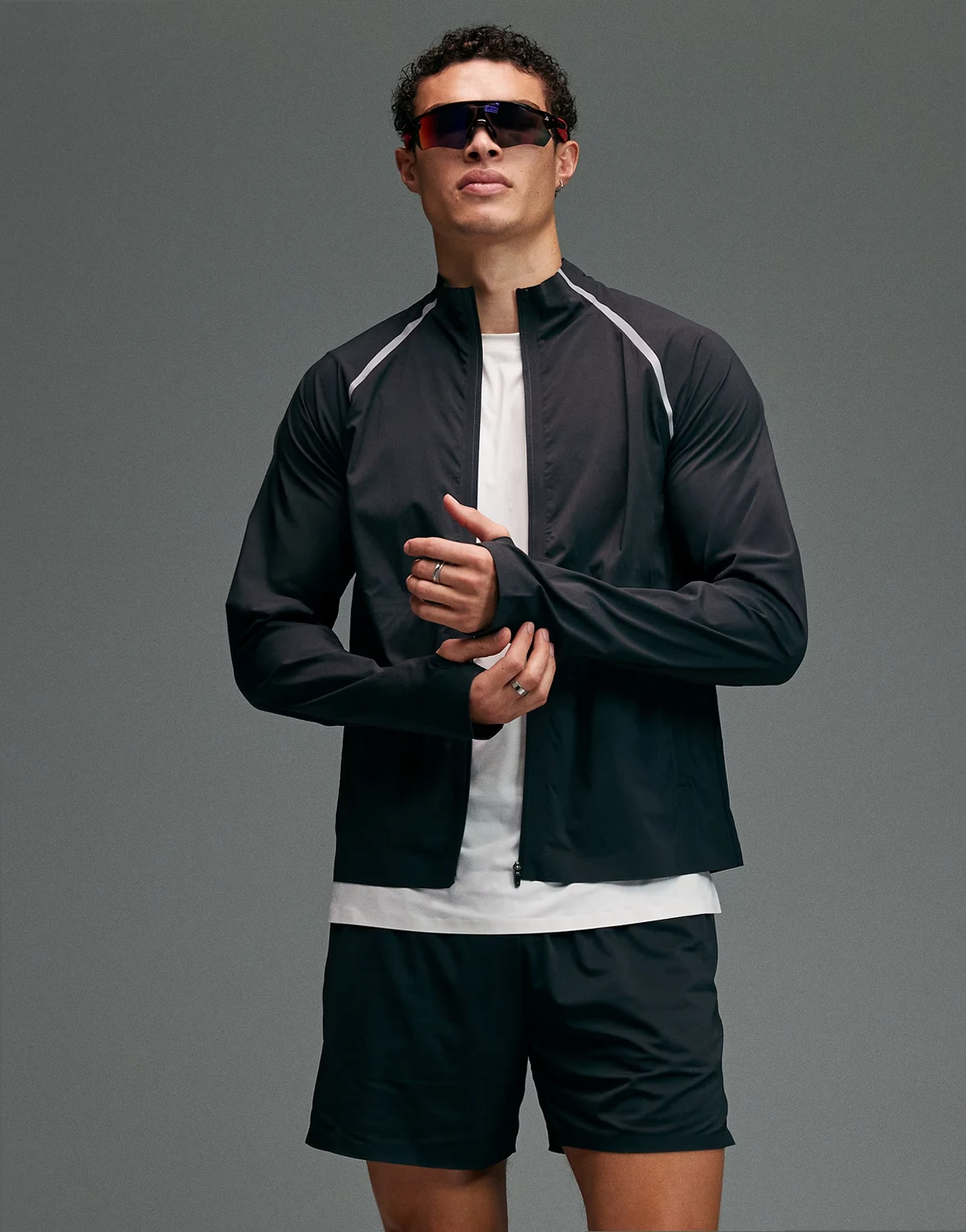 Premium – Wasserabweisende Laufjacke aus Webstoff in Void Schwarz mit Reißverschlusstaschen und reflektierenden Details