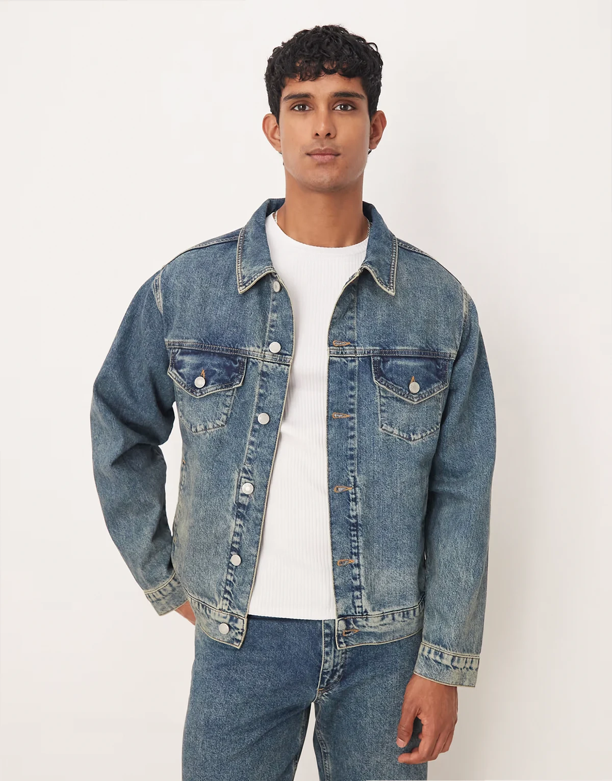 denim trucker jacket in mid wash blue with yellow tint - part of a set