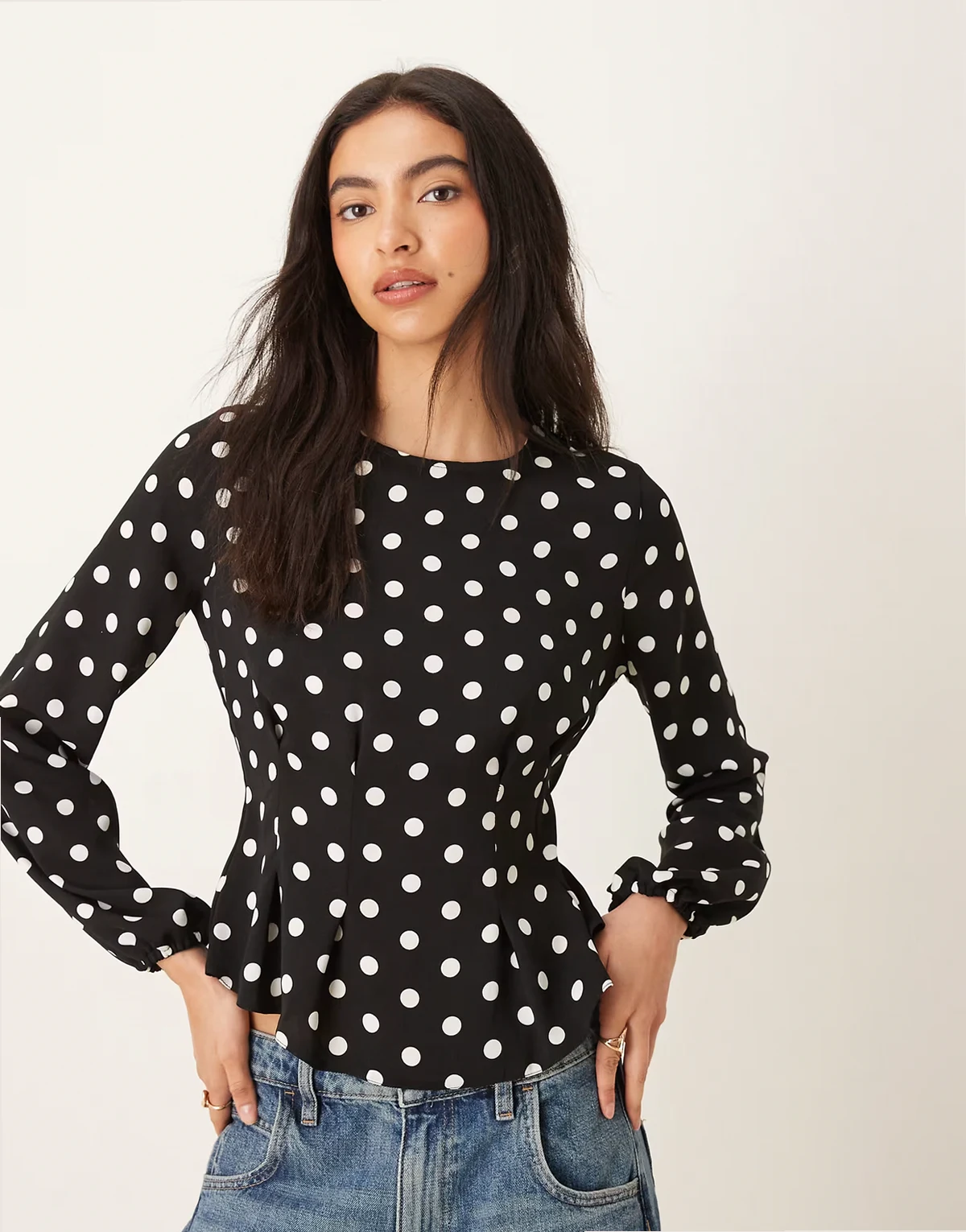 long sleeve peplum top in polka dot