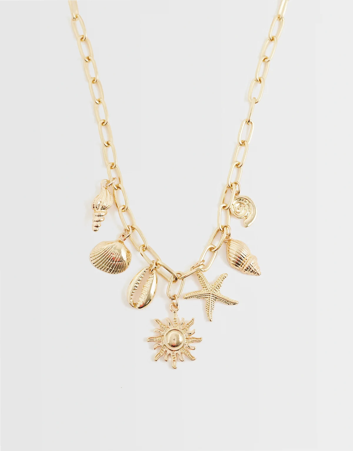 sea shell charm necklace in gold