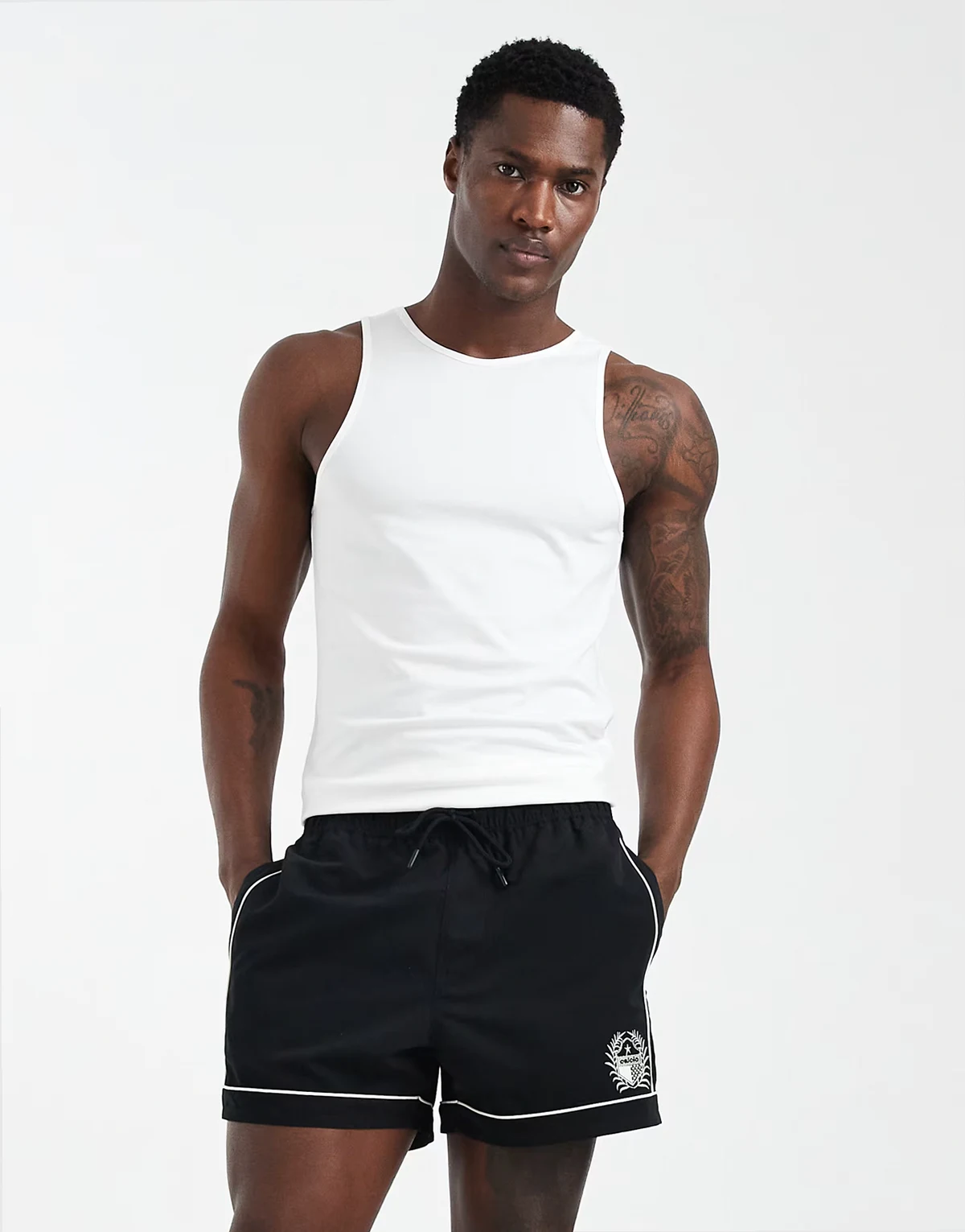 swim shorts in short length with piping and embroidery in black