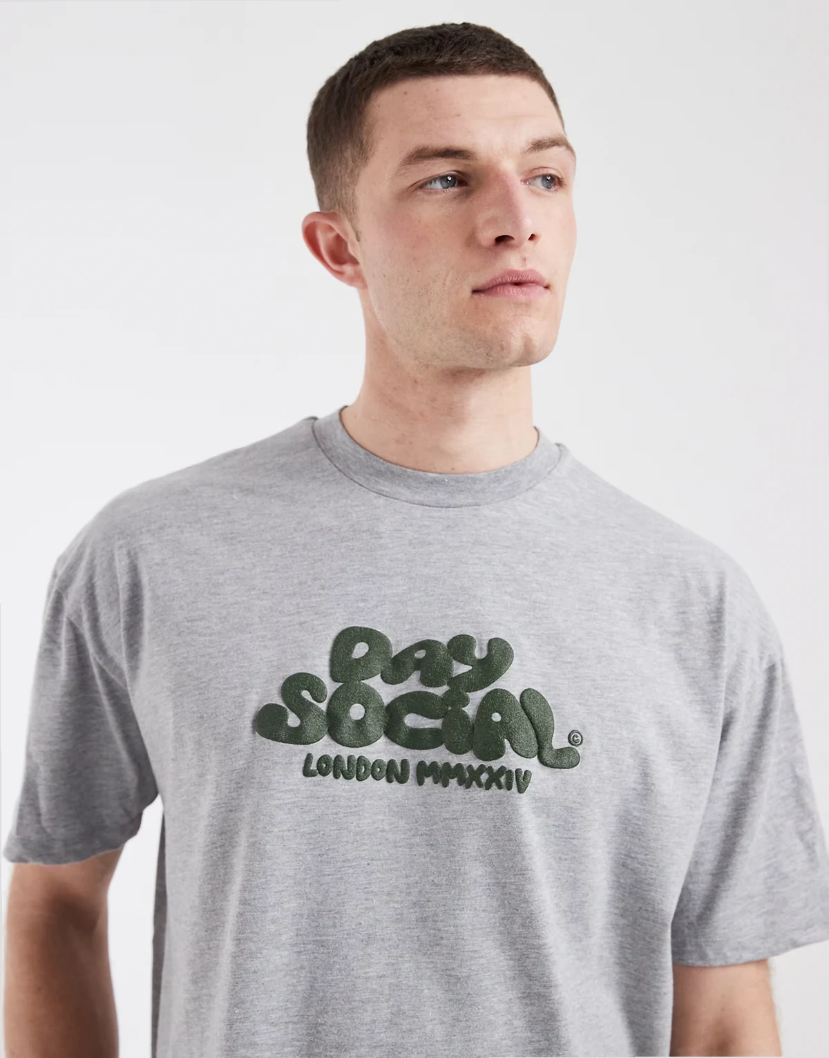– Pudełkowy T-shirt oversize w szarym melanżowym kolorze z zaokrąglonym napisem