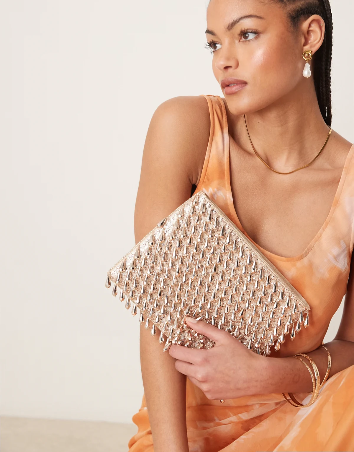zip top clutch bag in all over beads in rose gold