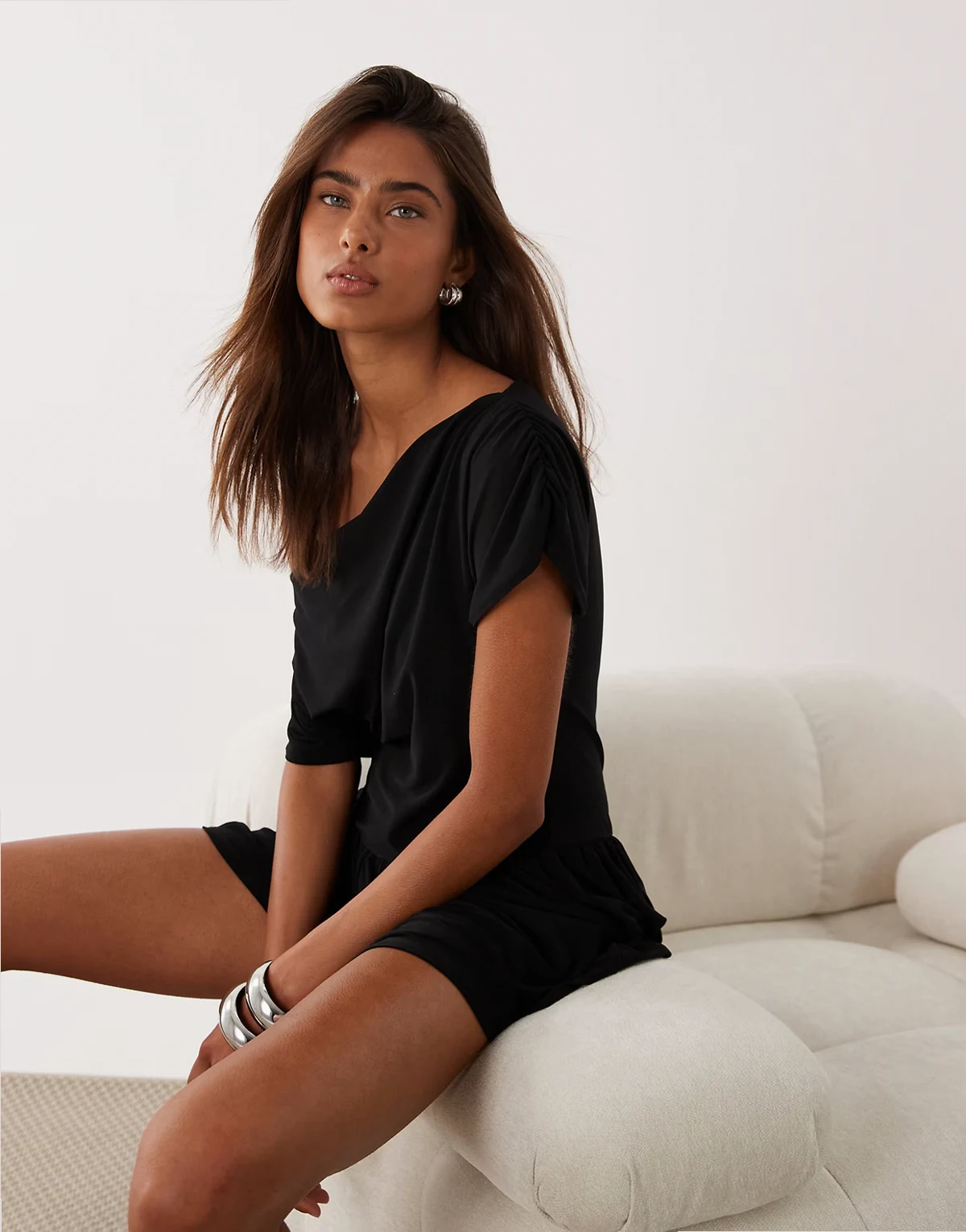 off-shoulder romper with flared shorts in black
