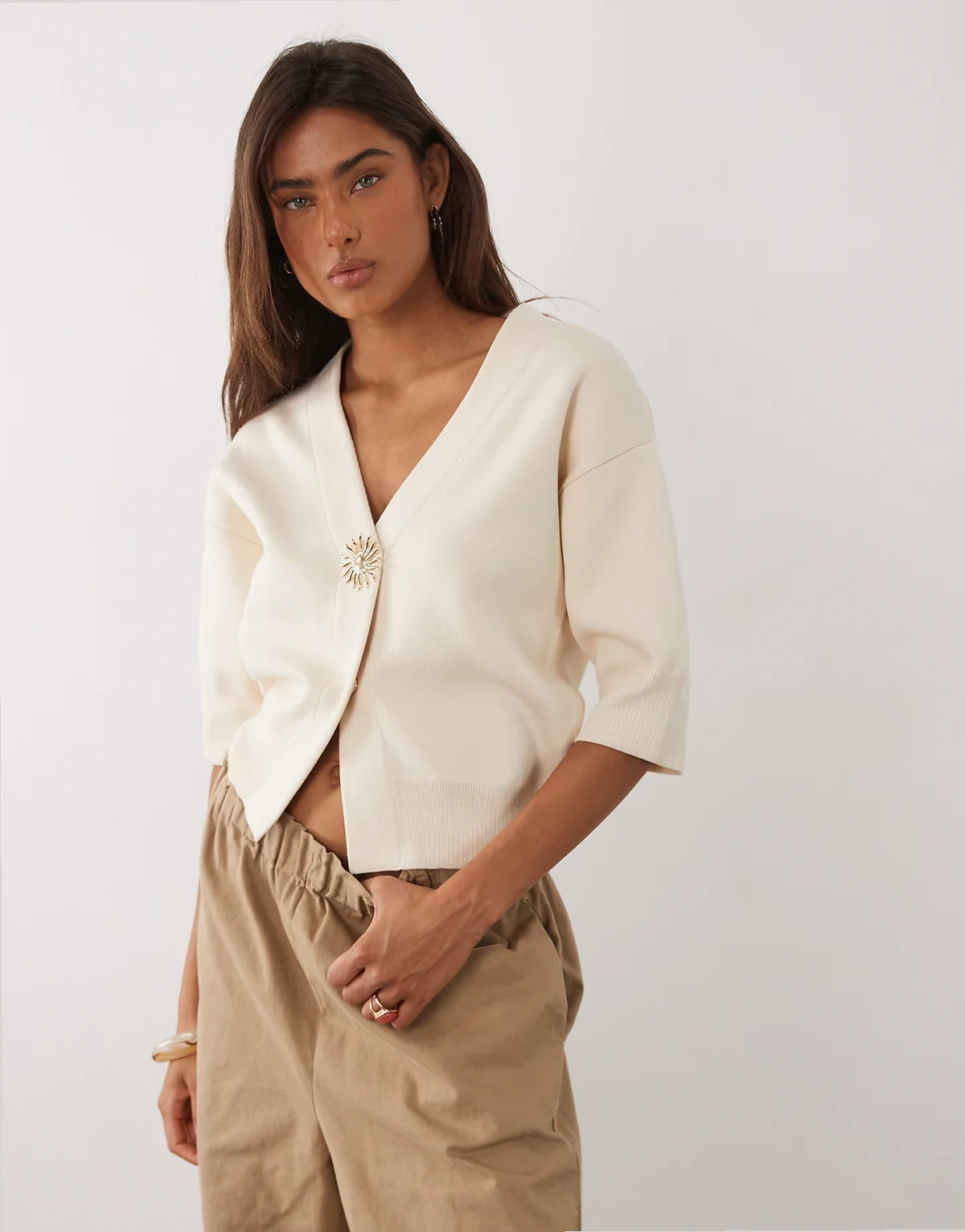 compact knit short sleeve cardigan with statement sunshine button in cream
